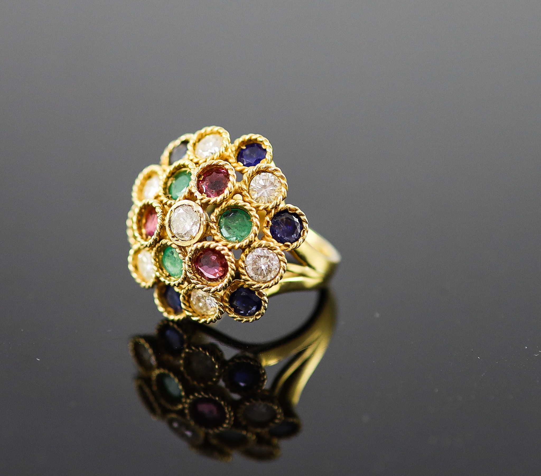 A continental gold (stamped 850) and multi gem set circular dress ring